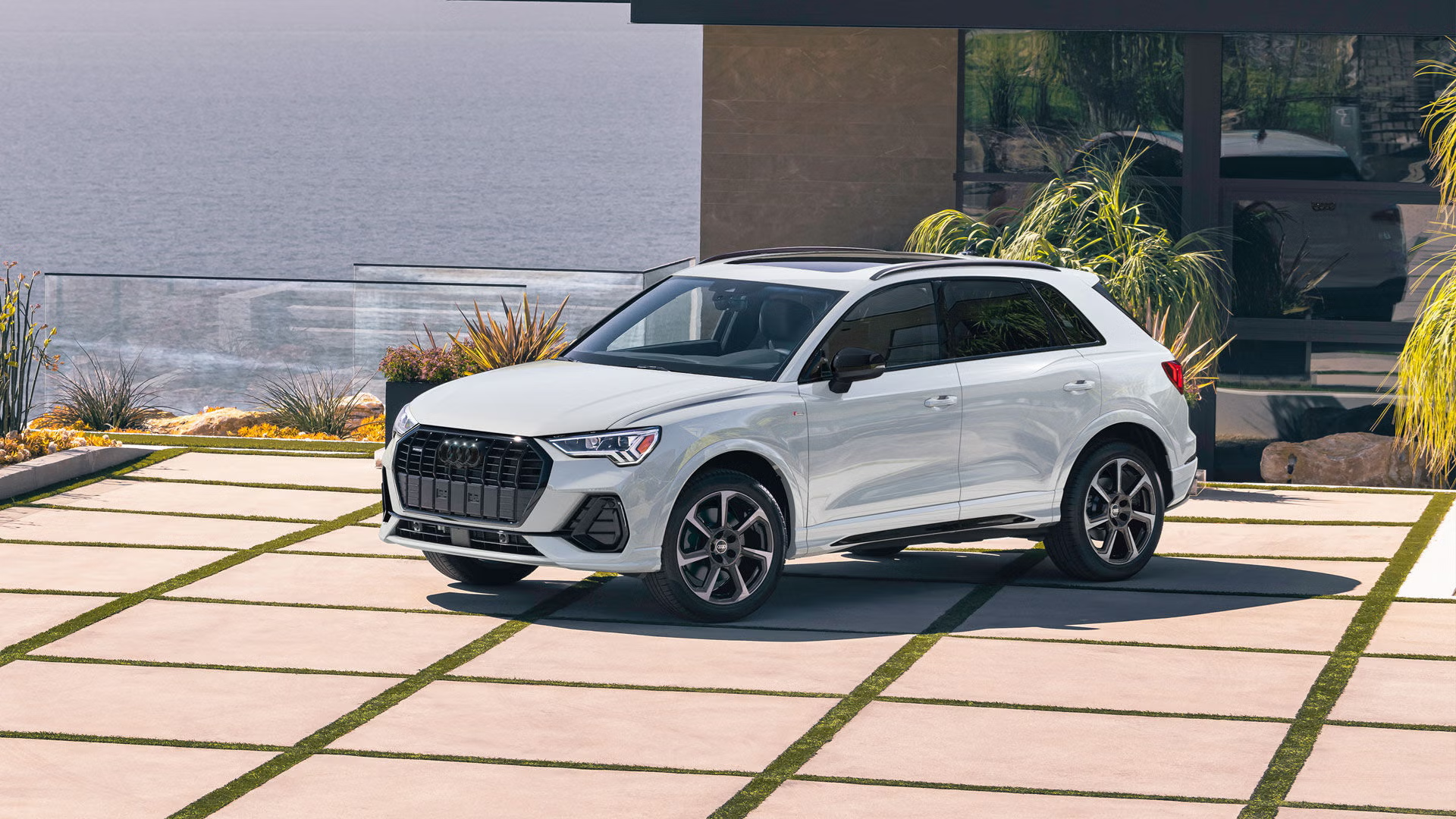 Front profile view of an Audi Q3 parked.